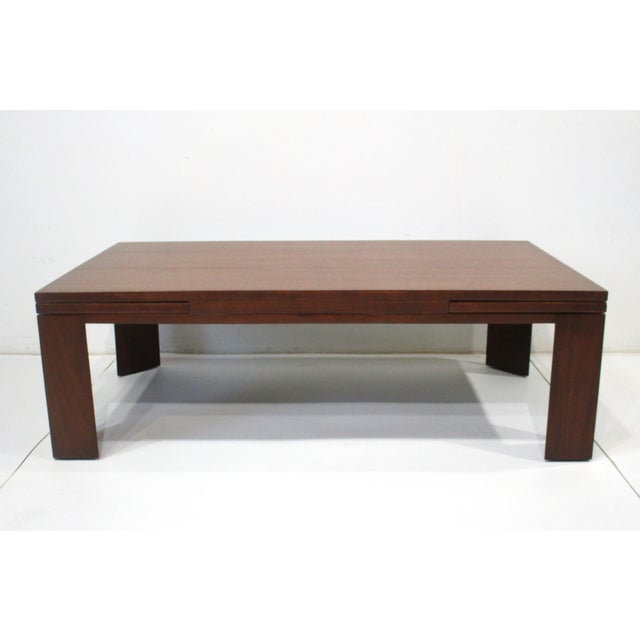 A very well crafted Mid Century mahogany expandable refectory coffee table with sliding ends that pull out and snap into...