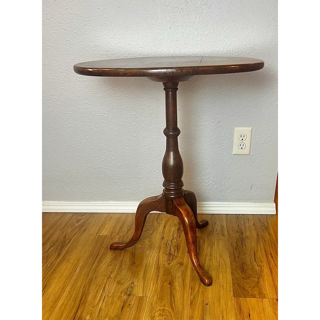 A finely crafted 19th century mahogany snake-foot tripod pillar table, executed in the English Regency tradition and...