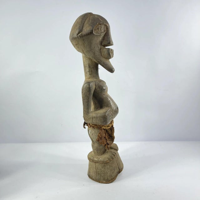 This figure has a strongly defined body and the well-known Songye jutting chin and geometric nose with the eyes...