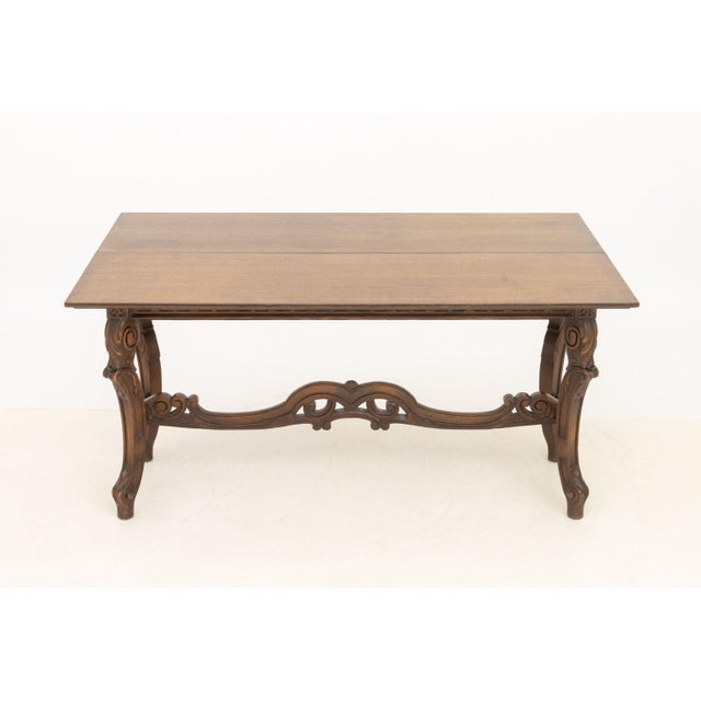 Rococo Style Walnut Extending Trestle Table, the flip-top with carved fan and floral bands above carved foliate cabriole...