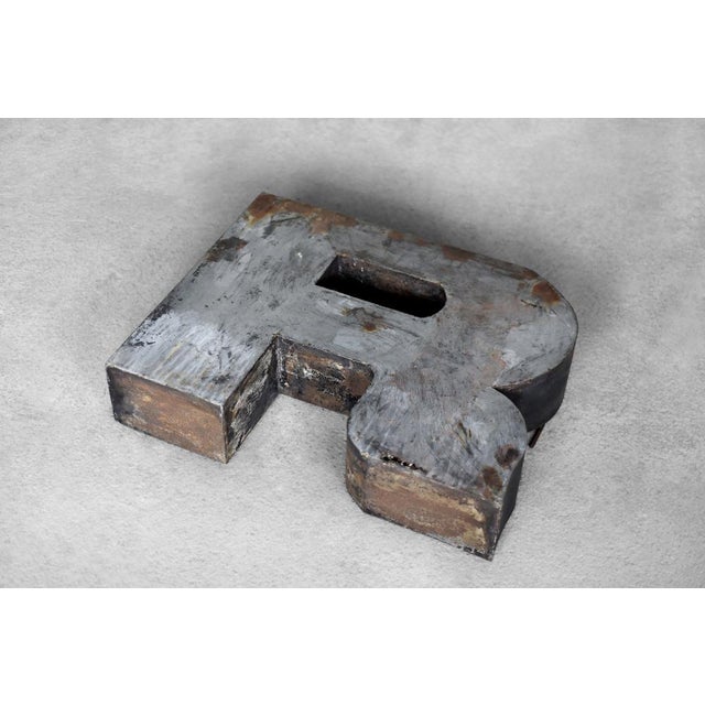This large, spatial letter R was produced in Poland during the 1950s. It was made of metal. It is an original element of...
