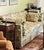 Elegant custom chinoiserie sofa featuring a beautifully detailed scenic floral upholstery with pagoda and botanical motifs...