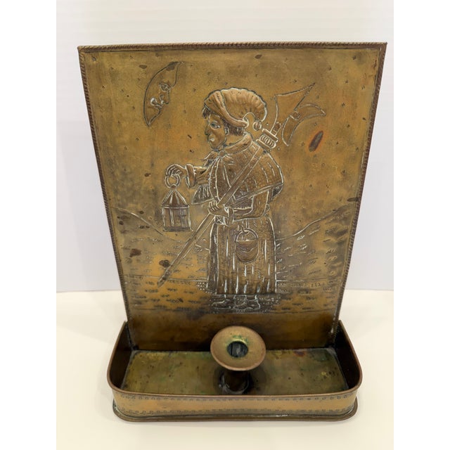 The highly collectible fireplace match holder is a quintessential piece of the late 19th-century British metalwork....