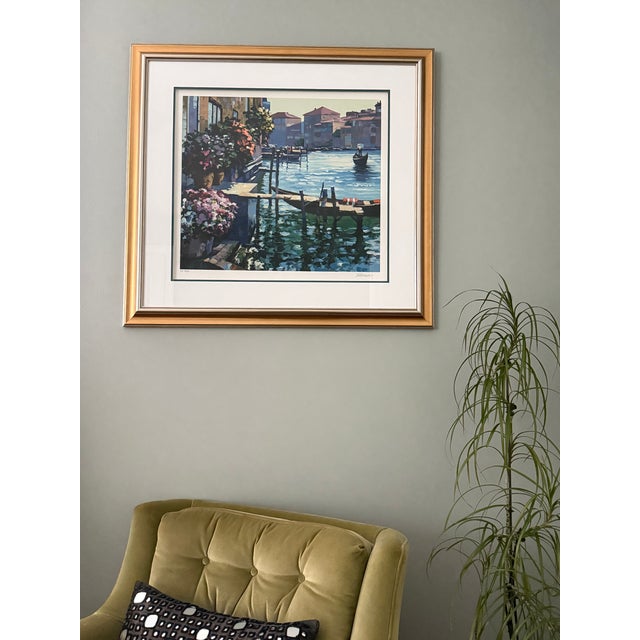 This serigraph by Howard Behrens depicts homes with flower boxes along a canal in Venice. It is beautifully framed and...