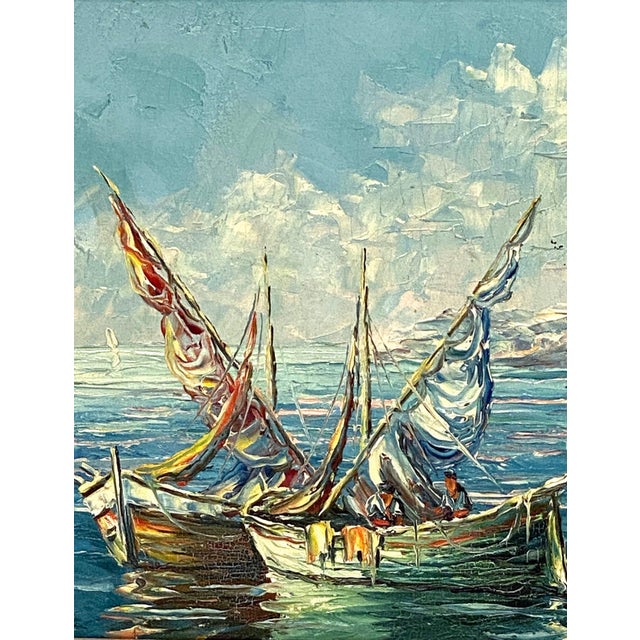 A fine French oil painting on canvas of a Mediterranean harbour scene, featuring a view of sailboats and a picturesque...