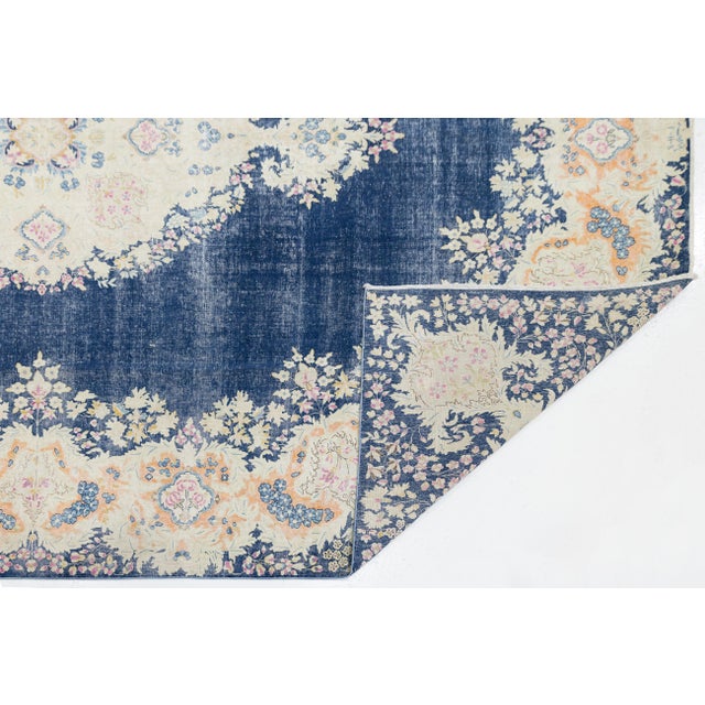 This exquisite Antique Kerman wool rug showcases the timeless elegance of Persian craftsmanship. It features a striking...