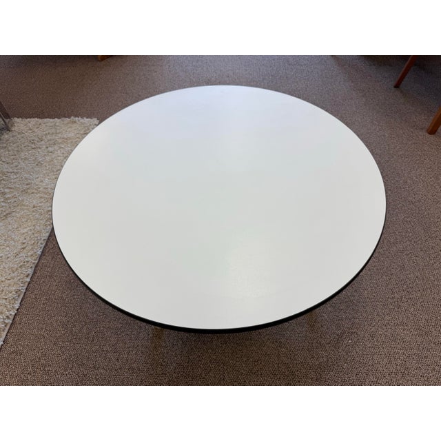 1960’s Mid Century Modern Herman Miller Eames Aluminum Group coffee table. The table features a white laminate top with a...