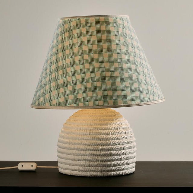 Table lamp with a woven-effect ceramic base and a textile lampshade from the 1980s. The ceramic base of the lamp is in...