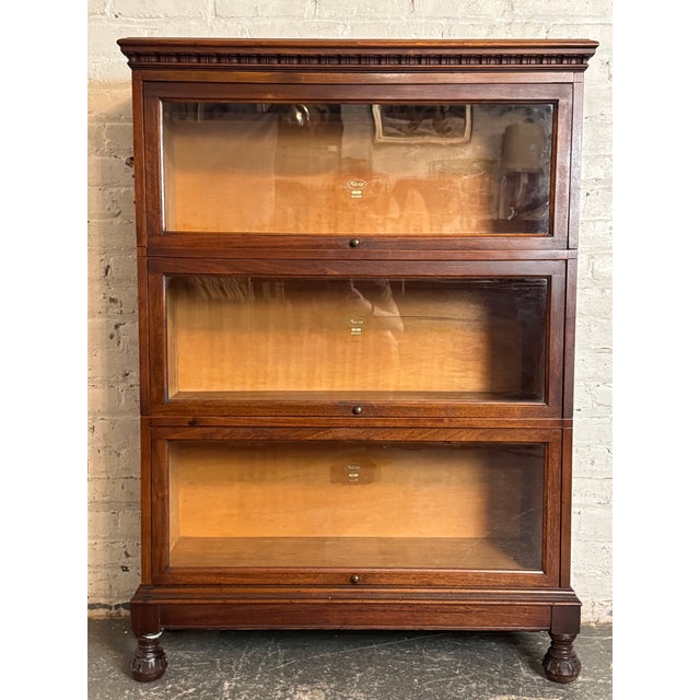 This antique Macey's barrister bookcase is made up of three case pieces each accompanied by there original sliding glass...