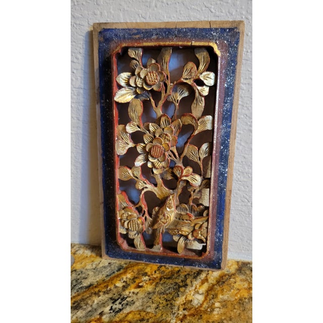 Beautiful one of a kind carved wooden plaque hand painted in red, gold and blue. Depicting a floral and bird design.