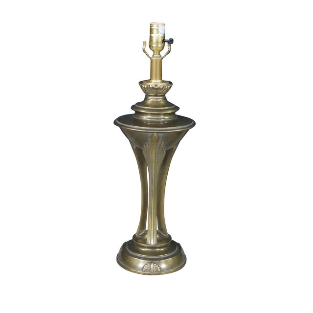 Pair of Art Deco Hollywood Regency style brass table lamps displays a striking, architectural silhouette defined by...