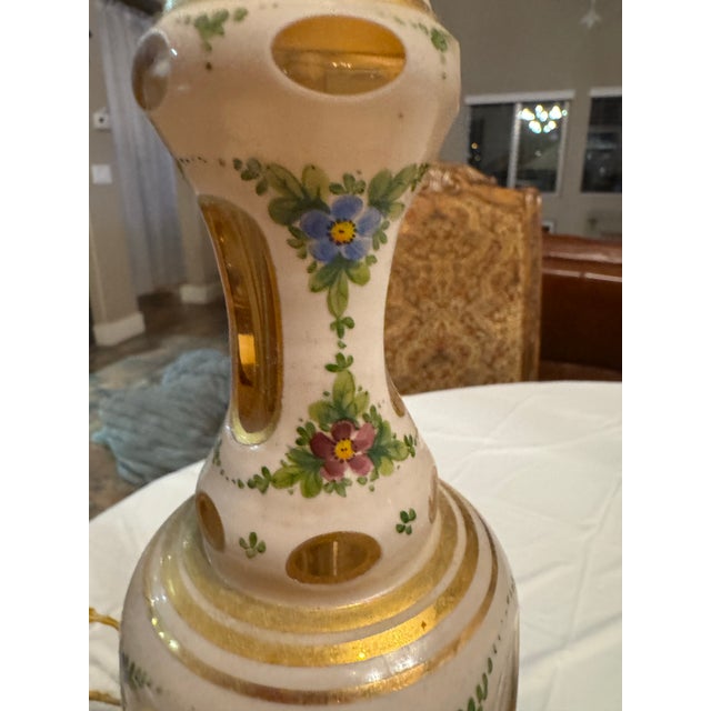 The lamp’s ornate appearance and fine detailing are characteristic of traditional Bohemian glasswork, known for its...