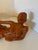 The piece is coated in a brilliant, high-gloss burnt orange ceramic glaze that beautifully accentuates its dramatic...