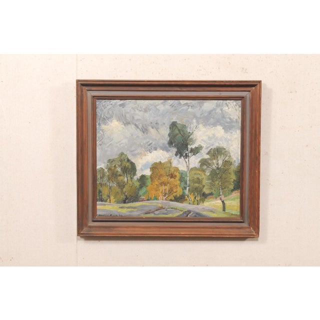 A European landscape with trees, oil on canvas, framed, Circa 1932. This antique painting from Europe depicts a tree-lined...