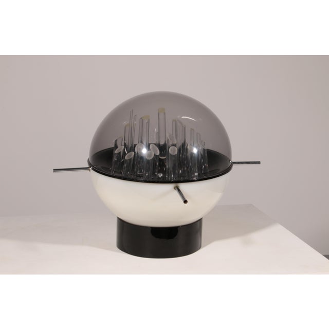 A striking and unique sculptural table lamp by Gaetano Missaglia, Italy, 1970s. The lamp features a composition of various...