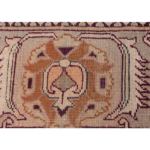 This late 19th Century Indian Amritsar rug features a rectangular field of leaf and floral designs along with curlicue...