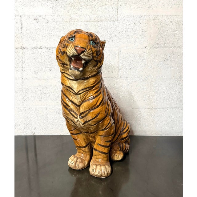 Vintage cast resin tiger sculpture presented in an upright seated pose with an open mouth, exposed teeth, and expressive...