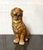 Vintage cast resin tiger sculpture presented in an upright seated pose with an open mouth, exposed teeth, and expressive...