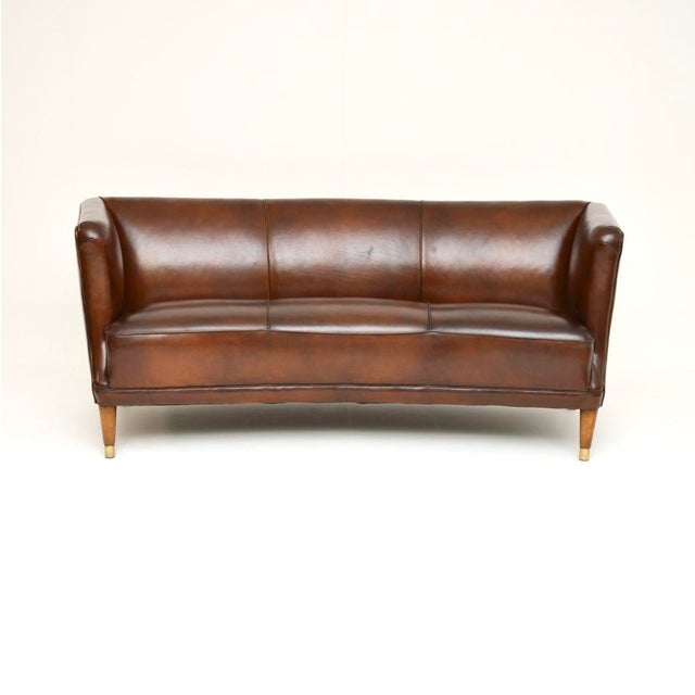An absolutely stunning and extremely well made vintage Danish cabinetmaker leather sofa. This was recently imported from...