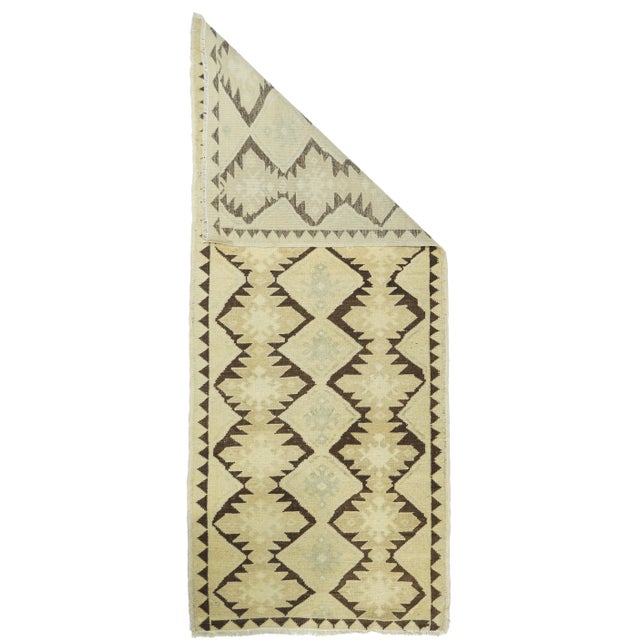 Figure versus ground. The red-brown field shows two columns of ashiks enclosing pale straw hooked diamonds, with...