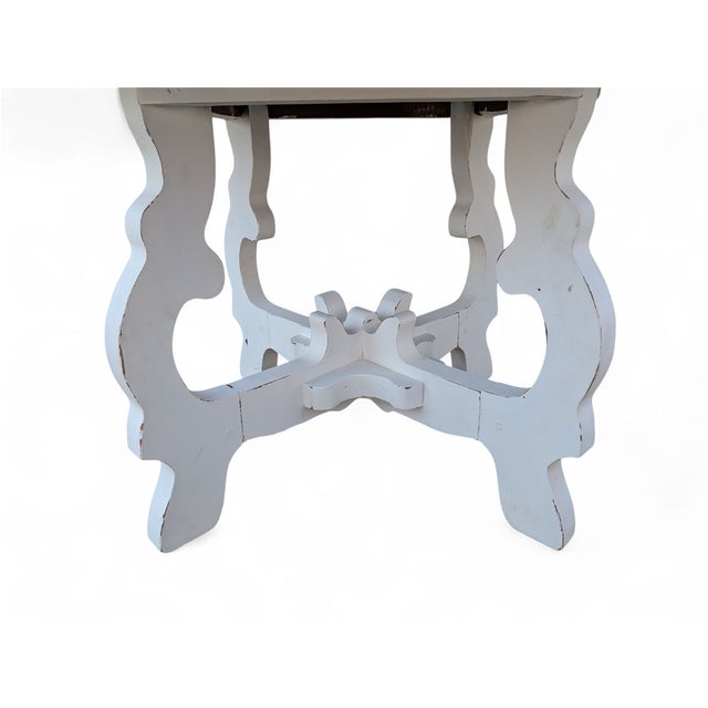 A coffee table with a simple yet distinctive design, featuring an octagonal top crafted from solid chestnut wood, prized...