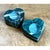 This pair of candle holders is carved from a richly patterned natural stone, its deep forest and teal-green tones threaded...