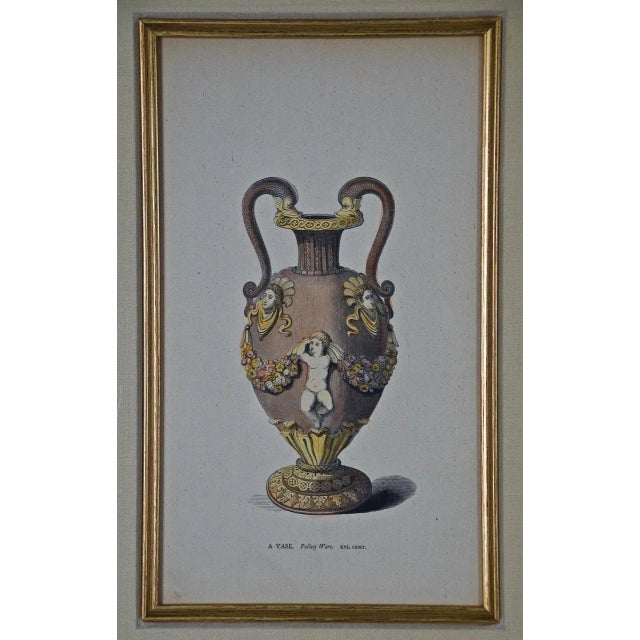 This is a pair of framed hand-colored engravings of an ancient vase in the Palizzy Wares style and a silver gilt tazza...