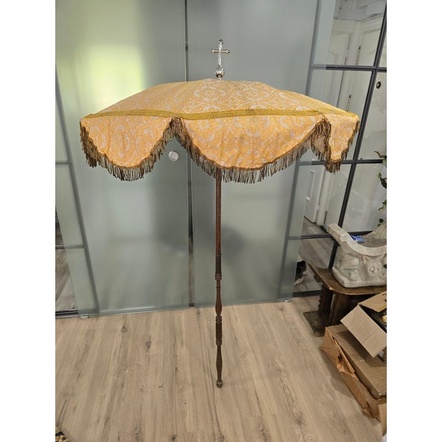This intriguing 19th century religious parasol features a silver cross and fabric sewn with gold thread. It is in...