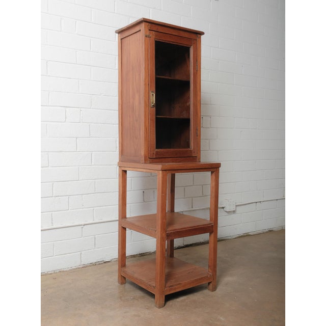 This charming wooden glass-front cabinet offers a warm, rustic presence and versatile function. Crafted from solid wood...