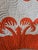Traditional Hawaiian design with symmetrical appliqué in deep orange over white, echo-quilted by hand in spiral and...