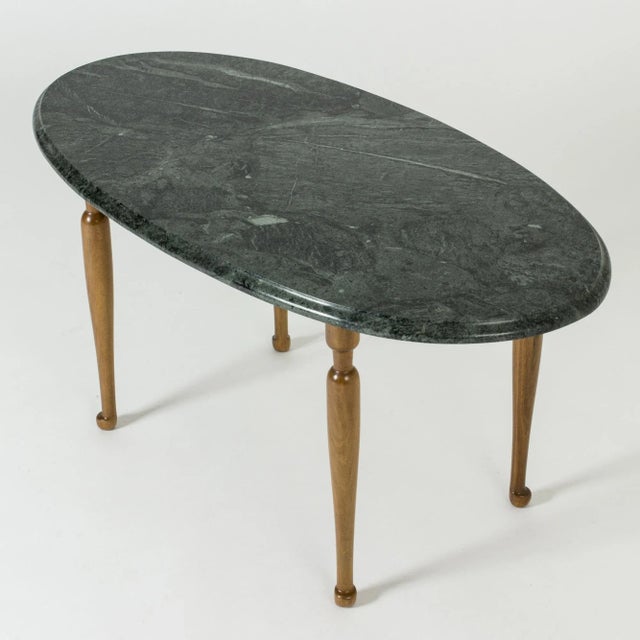 Beautiful side table by Josef Frank, with an oval green marble table top on a slender mahogany base. Deep green marble,...