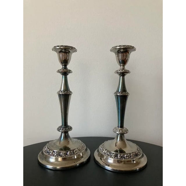 A beautiful pair of tall English candlesticks, circa 19th century, England, Europe. A shiny pair of candlesticks for...