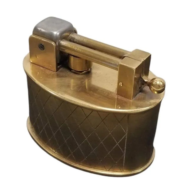 Circa 1950 Made in Switzerland made by Brilux and distributed by Dunhill. Beautifully made brass lighter with spring lift...
