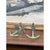 A pair of vintage decorative wall-mounted candle holders crafted in the form of anchors. Each piece features a stylized...