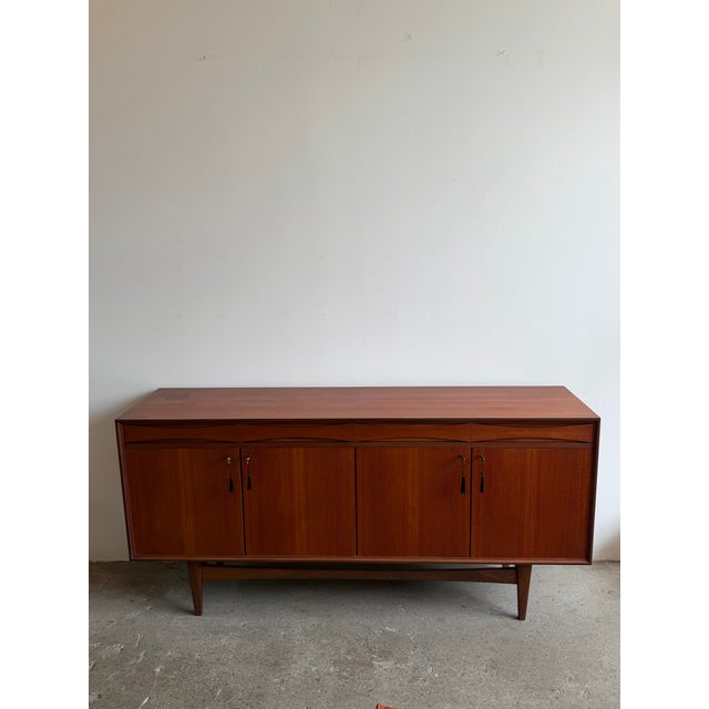 Norwegian teak sideboard attributed to Gustav Bahus, produced in the 1960s. The case features four key locking cabinet...