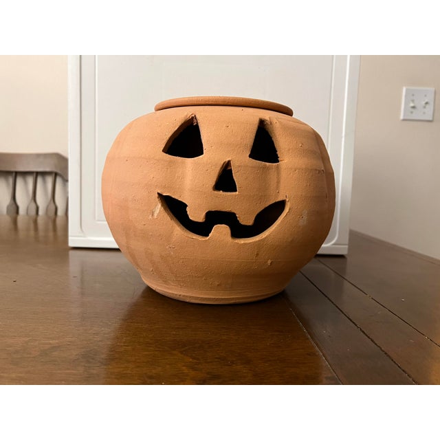 Add a touch of rustic charm to your seasonal decor with this delightful vintage red clay jack-o'-lantern. This unique...