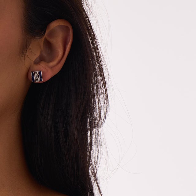 These elegant Art Deco sapphire and diamond stud earrings are a classic 1930’s design, featuring 12 baguette cut sapphires...
