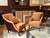 A lovely pair of transitional upholstered lounge chairs with brown and orange brushed chenille fabric and matching accent...
