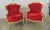 A pair of Louis XV style Wing Chairs. Detailed carved frames with flowers and musical instruments, red tufted velvet...
