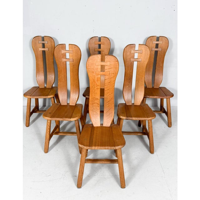 Set of 6 brutalist dining chairs, oak, belgium, 1970s. This set consists of six oak chairs with high backs and splayed,...