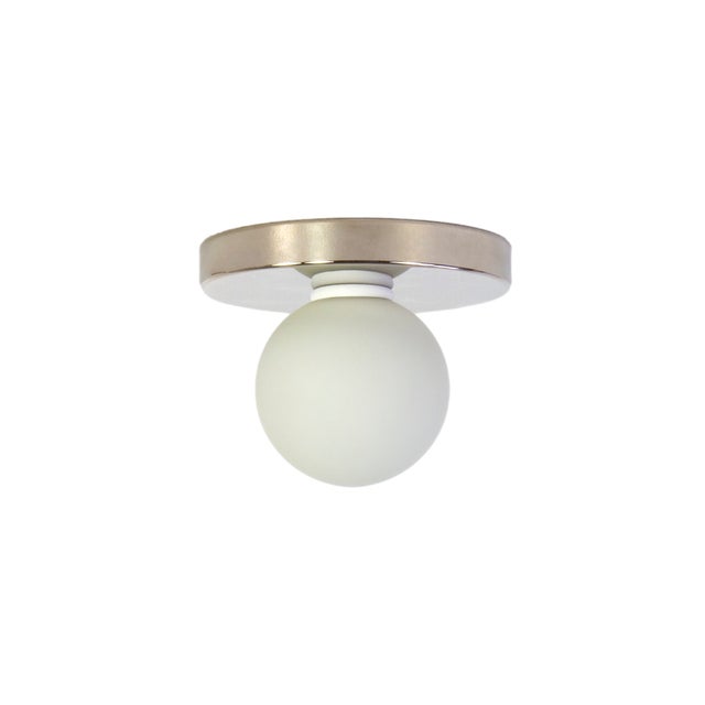 Minimal from top to bottom. This black flush mount pairs a metal base with a soft glass globe. Cool, calm, and quietly...