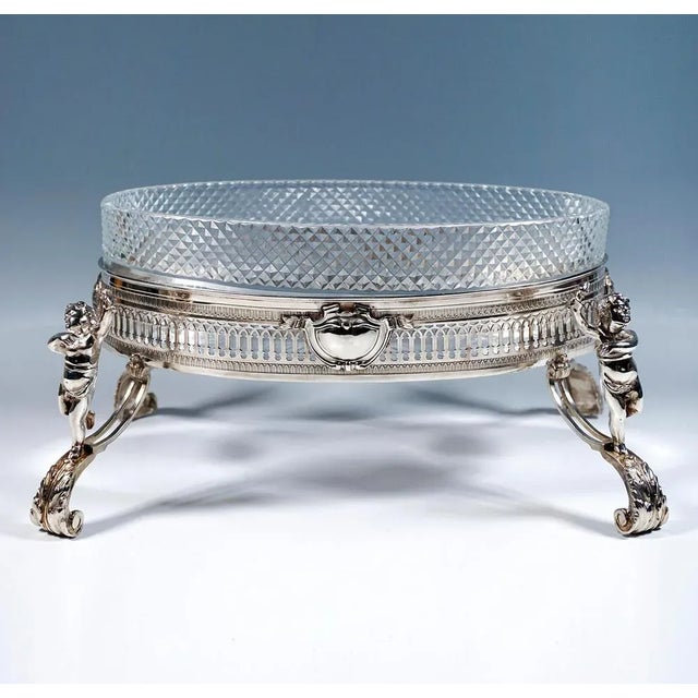 Exceptional and elegant silver jardinière of elliptical basic form on high curved volute legs with attached fully plastic...
