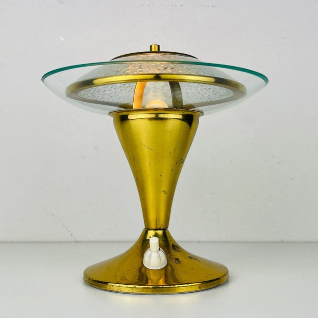 The charming table lamp made in Italy in the 1970s. Its beautiful color and light patina give to it grace and charm. The...