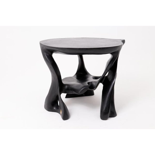 This extraordinary coffee table is a one-of-a-kind masterpiece, hand-carved from a single solid hardwood log. Its complex,...