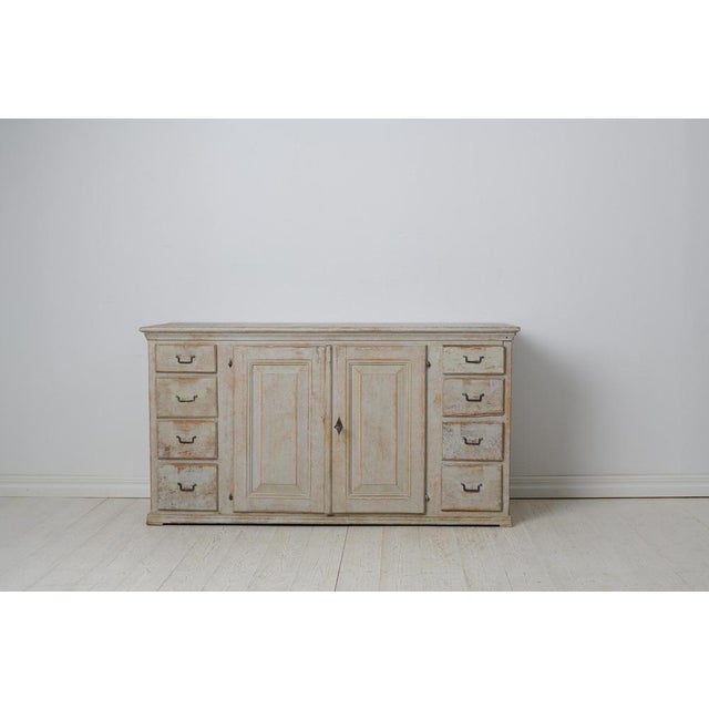 Early low and wide sideboard from 19th century Sweden. This genuine country house furniture was made around 1820 to 1830...