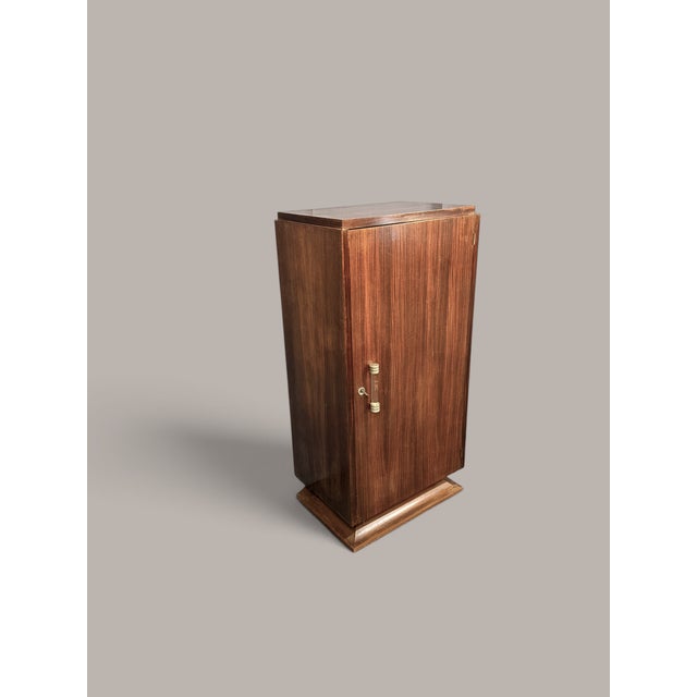 An elegant, slim bar cabinet from France, dating from the Art Deco period, likely around 1930–1935. The piece is veneered...