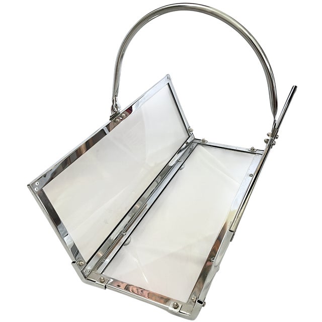 A sleek and sculptural chrome and smoked glass log holder designed by Danny Alessandro, Italy, circa 1970s. Equal parts...