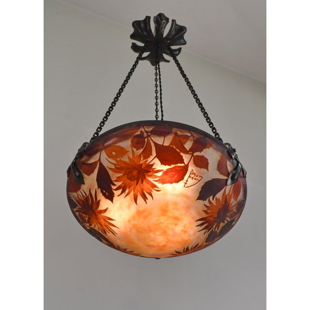 Daum freres & Louis Majorelle dahlia pinnata A 1920s French art deco pendant light in wrought iron with a rare cameo glass...
