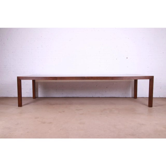 A gorgeous mid-century modern Parsons extension dining table By Henredon USA, Circa 1970s Carved oak, with parquet top....