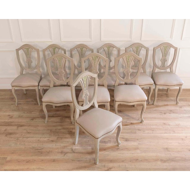 An elegant set of ten French chairs crafted in the Louis XV–Louis XVI transition style, dating to the twentieth century....